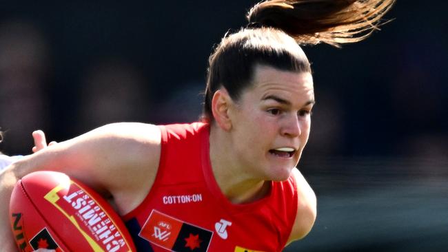 MELBOURNE, AUSTRALIA - SEPTEMBER 15: Lily Mithen of the Demons is tackled during the round three AFLW match between Melbourne Demons and North Melbourne Kangaroos at Casey Fields, on September 15, 2024, in Melbourne, Australia. (Photo by Quinn Rooney/Getty Images)