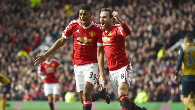 Marcus Rashford of Manchester United celebrates scoring his opening goal with Juan Mata.