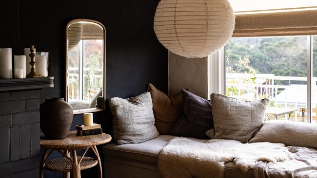 The inviting custom-made day bed adorned with soft, plump linen cushions and cosy sheepskin rug are lovely additions to the lounge at Sandy Bay Airbnb The Binney. Picture: Dearna Bond