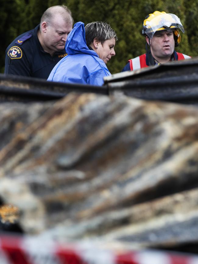 Police and fire investigators at the scene of a house fire at Fourfoot Rd, Geeveston. Picture Chris Kidd