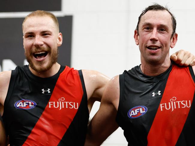 MELBOURNE, AUSTRALIA - MARCH 16: Ben McKay and Todd Goldstein of the Bombers sing the team song during the 2024 AFL Round 01 match between the Essendon Bombers and the Hawthorn Hawks at the Melbourne Cricket Ground on March 16, 2024 in Melbourne, Australia. (Photo by Dylan Burns/AFL Photos via Getty Images)