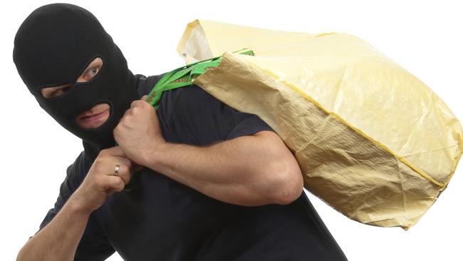 Robber in a mask carries big bag with money. Robbery. Theft. Burglar. Generic image.