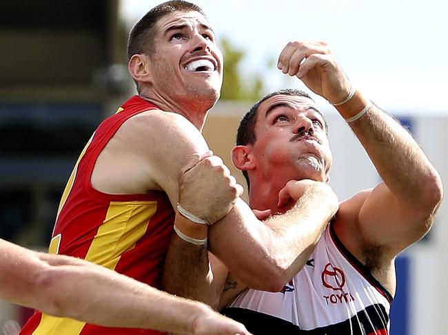 AFL - Adelaide Crows v Gold Coast at Noarlunga Oval. Taylor Walker contests the boundary throw in with Zac Smith Picture SARAH REED