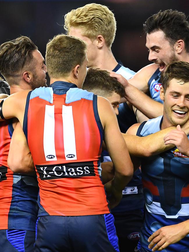 Taylor Duryea is mobbed by teammates after kicking his first goal for the Bulldogs. Picture: Quinn Rooney/Getty Images.