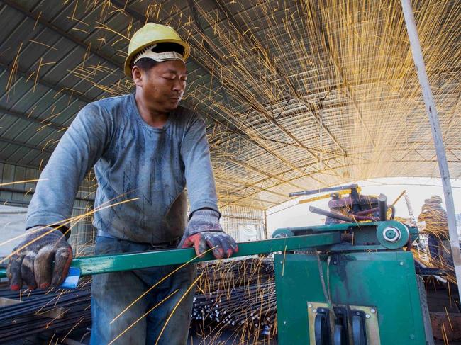 Steel bars being cut in Jiangsu province. An easing of production restrictions on raw materials—such as coal and steel—is boosting output and weighing on prices. PHOTO: CHINA DAILY/REUTERS