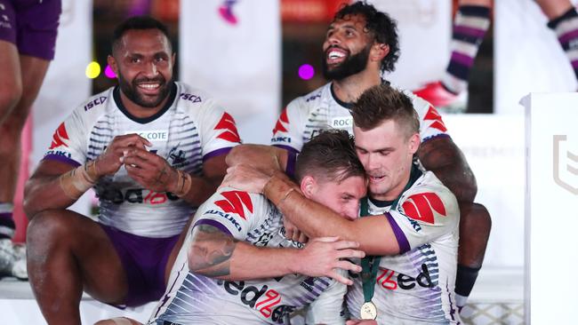 Ryan Papenhuyzen gives Cameron Munster a hug after Storm won the decider.