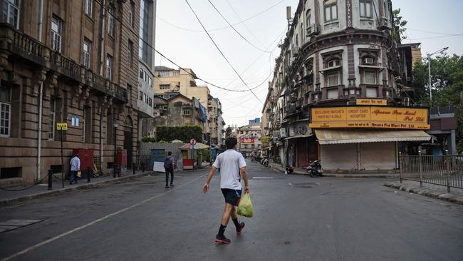 A pedestrian walks along a near-deserted street in Mumbai. Picture: Fariha Farooqui/Getty Images