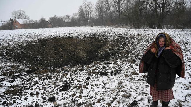 Yaroslava Sukach, a local resident whose house was destroyed stands next to a crater following a strike on the village of Sknyliv, near Lyiv on January 15. Picture: AFP