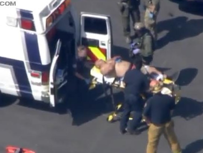 A male, believed to be the injured guard, is trsnported to an ambulance. Picture: KTLA 5.