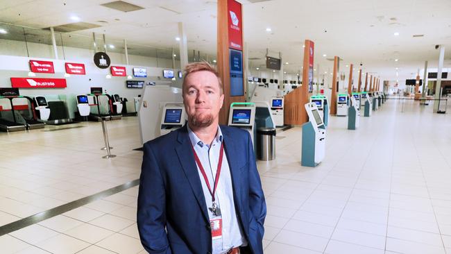 Chris Mills in an empty Gold Coast Airport check in area. Photo Scott Powick Newscorp