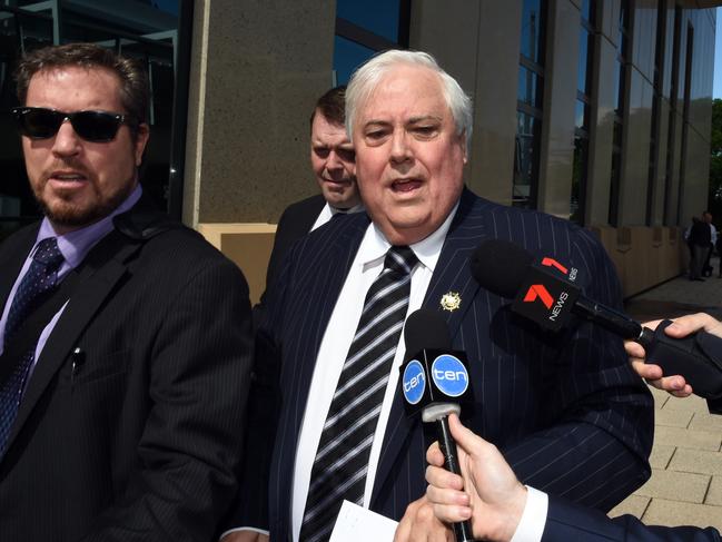 Businessman Clive Palmer, flanked by security guards, arrives at the Federal Court in Brisbane, Friday, Sept. 16, 2016. The former federal MP will continue to give evidence under oath about the demise of Queensland Nickel, which was put into liquidation earlier this year. (AAP Image/Dan Peled) NO ARCHIVING