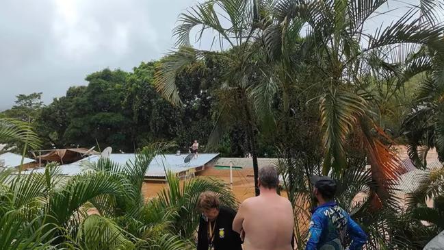 The Lions Den Hotel staff on the roof of the hotel waiting to be rescued by chopper pilot Migaloo. Picture: Lions Den Hotel