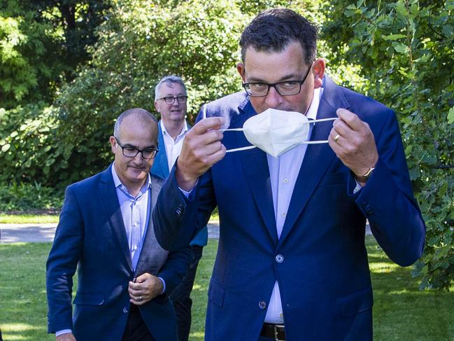 MELBOURNE, AUSTRALIA - NewsWire Photos February 17, 2022: (L-R) Victorian Premier Daniel Andrews puts on a mask after a press conference with Deputy Premier, James Merlino and Minister for Health, Martin Foley. Picture: NCA NewsWire / Aaron Francis