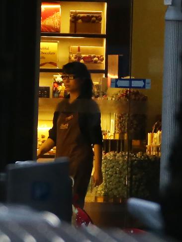 Fiona Ma goes to the front door to turn off the lights in the Lindt cafe during the siege. Picture: Craig Greenhill