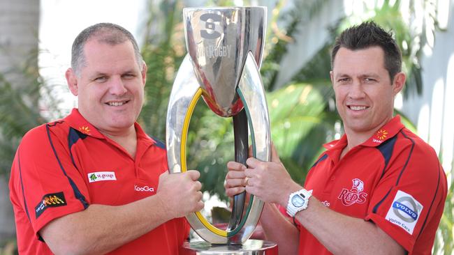 Queensland Reds assistant Matt Taylor (R) with the Super Rugby trophy. Picture: Fiona Harding