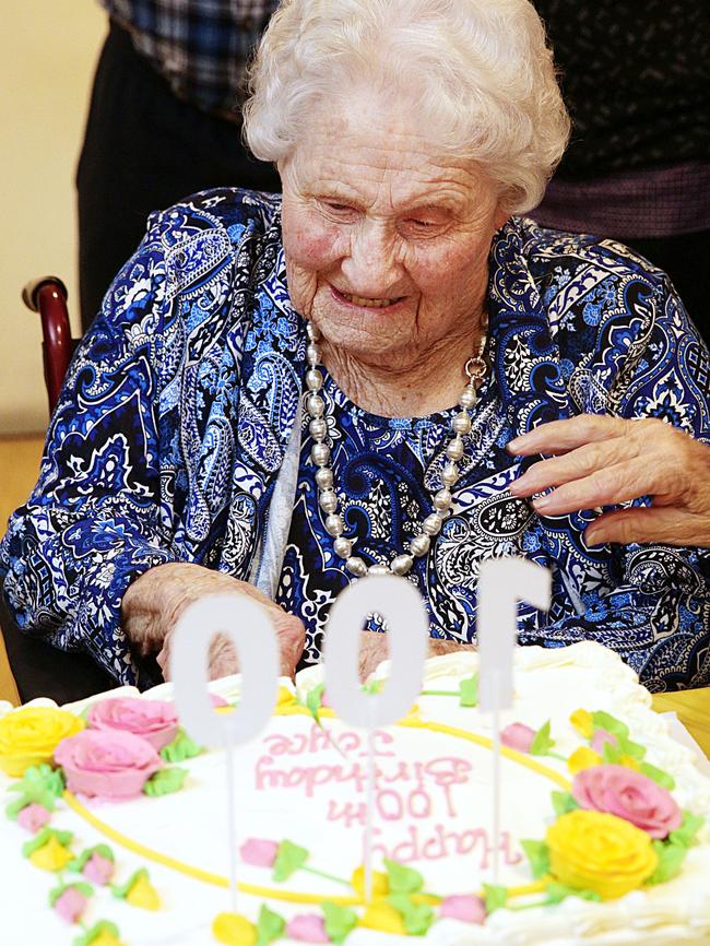 Joyce Worrad cutting her cake.