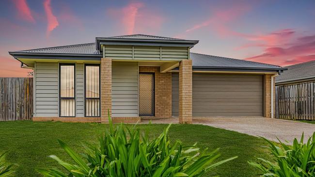 This four-bedroom house at 27 Adam St, Beachmere, has a price guide in the high $400,000s.