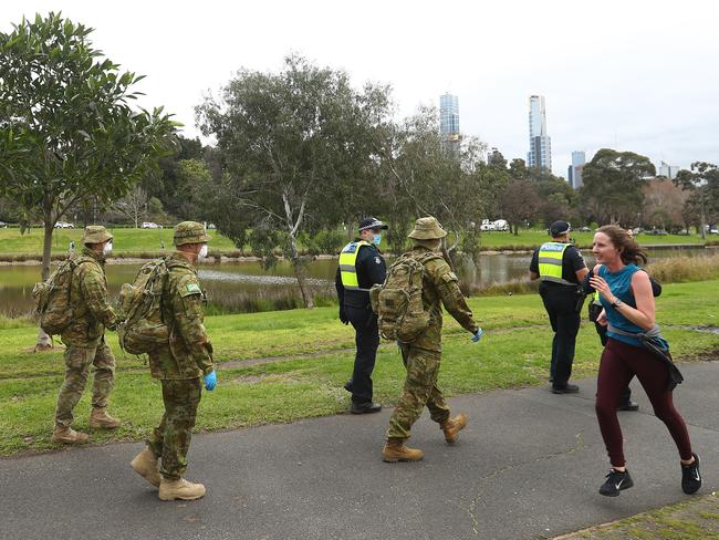 Police and the Australian military patrol the banks of the Yarra River in Melbourne. Picture: Getty Images