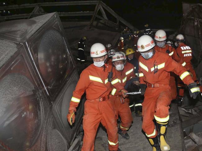 Rescuers evacuate an injured person from the rubble of a collapsed hotel building in Quanzhou city in southeast China's Fujian province. Picture: AP