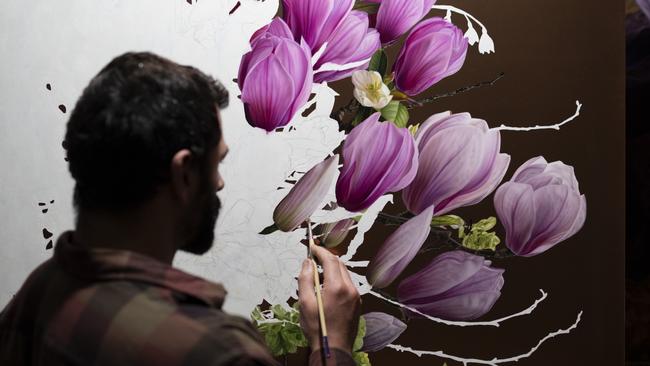 Sebastian Galloway paints magnolias - his favourite flower - on copper in preparation for his upcoming exhibition at Hobart's Handmark Gallery. Picture: Supplied