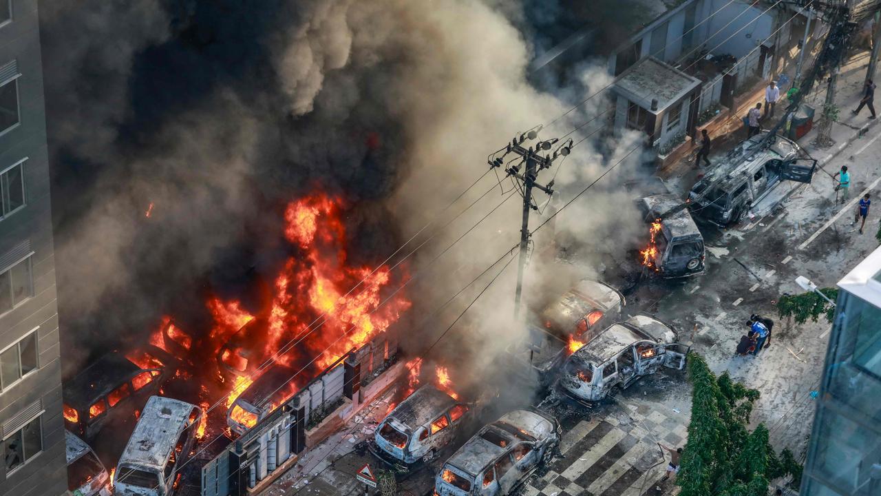 Smoke rises from burning cars after protesters set them on fire near the Disaster Management Directorate office on July 18. Bangladeshi students also set fire to the country’s state broadcaster. Picture: AFP