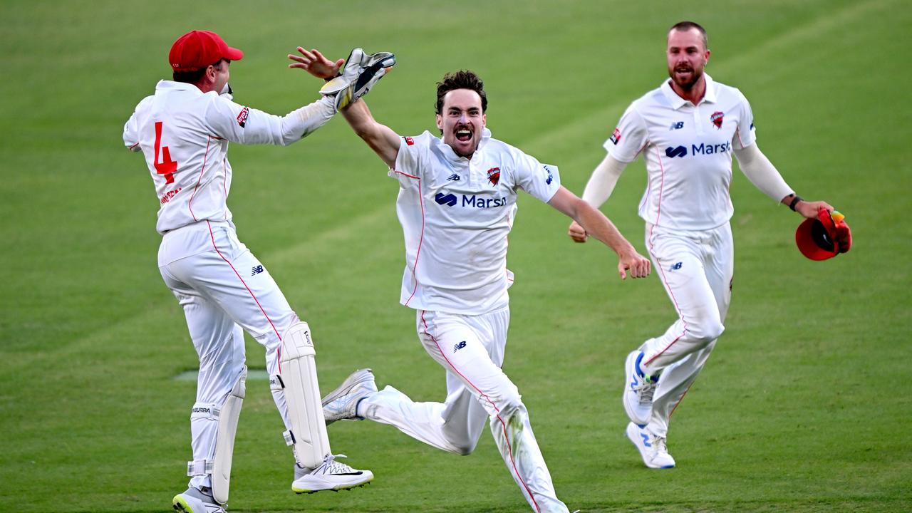 Jordan Buckingham (centre) claimed three wickets in a matchwinning spell late on day four to hand his Redbacks an epic three-run victory. Picture: Bradley Kanaris / Getty Images