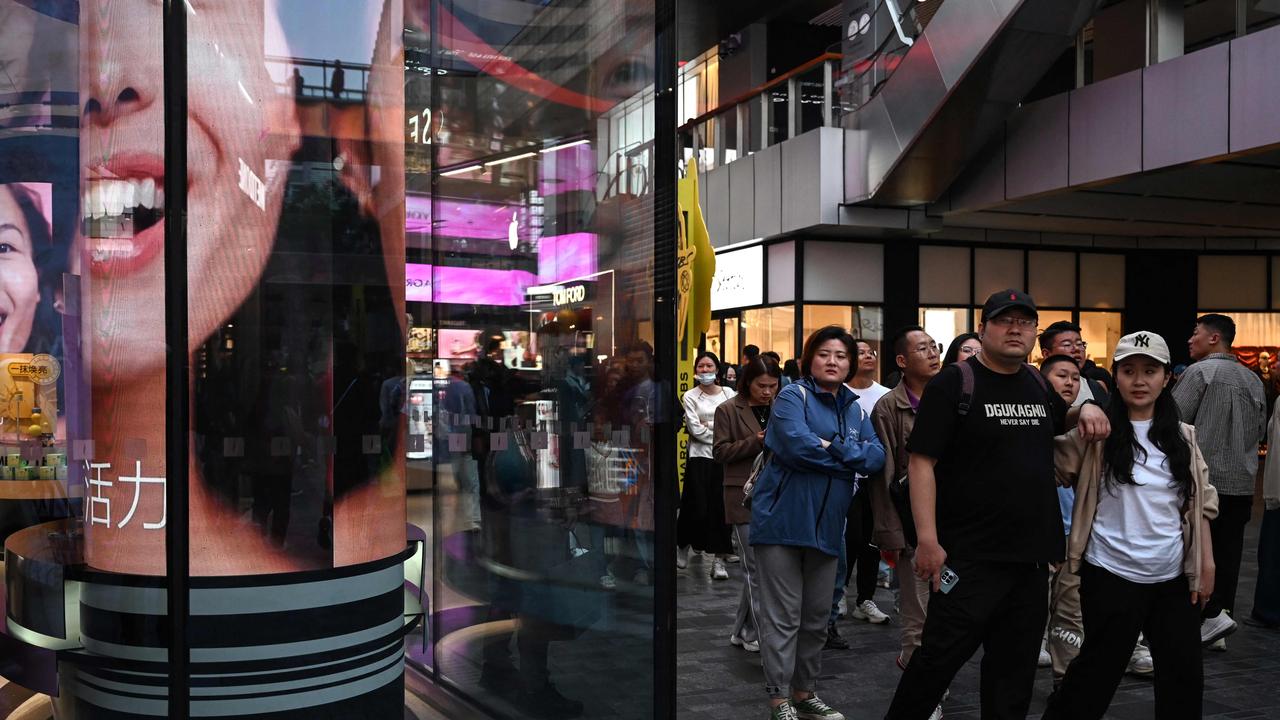 People walk in a Shanghai shopping mall during a week-long holiday during Golden Week. Picture: AFP