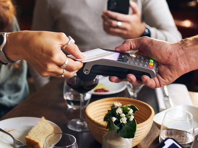 Woman paying with card in restaurant