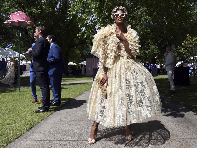 A racegoer shows off her elaborate outfit. Picture: William West