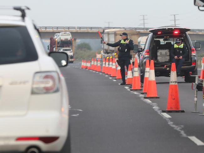 Police and Army personnel conducting a roadblock along the Princes Hwy near Little River, outbound toward Geelong. Picture: Alex Coppel.