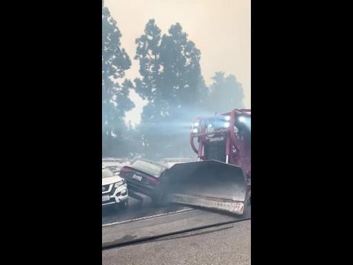 Fire Department Bulldozer Clears Abandoned Cars as Wildfires Threaten Los Angeles