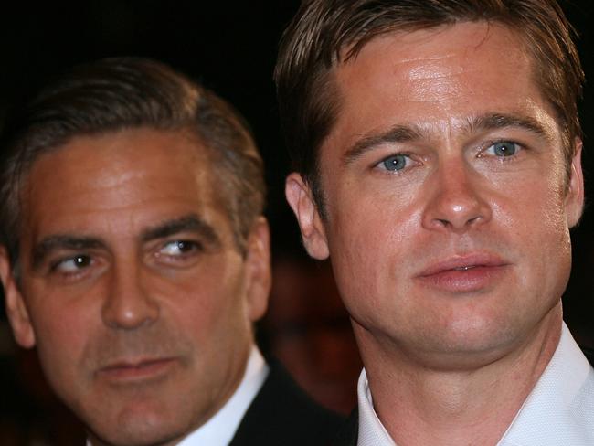 Actor, director and producer George Clooney (L) and fellow actor Brad Pitt 24 May 2007 leaving the Festival Palace in Cannes, southern France, after the premiere of film 'Ocean's 13' during the Cannes Film Festival. The film is presented in the Out of Competition category. AFP PicValery/Hache headshot serious