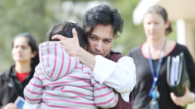 The relieved father with his young daughter after their family car was allegedly stolen with the girl inside. Picture: Mark Wilson