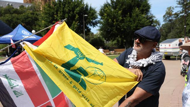 A protester pictured holding a yellow flag that looks like the Hezbollah flag but has Ned Kelly on it. Picture: NewsWire / Damian Shaw