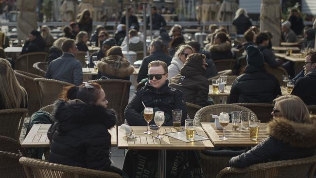 What pandemic? People chat and drink in Medborgarplatsen, Stockholm on Saturday.