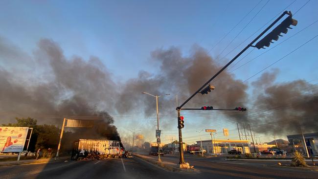 Parts of the city were set alight as civilians sheltered in their homes, as Culiacan became a warzone between the army and Sinaloa Cartel. Picture: Marcos Vizcarra / AFP