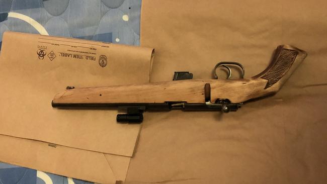 Inside McPhail’s St Mary’s home, they found a loaded, ready-to-fire .22 calibre shortened bolt action rifle standing upright behind the bed head. Picture: NSW Police Media