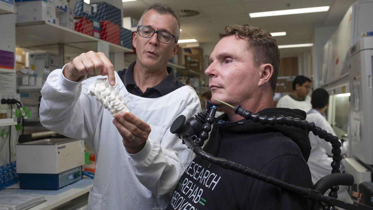 The Australian News World-first human clinical trial to cure paralysis Professor James St John holding a Cervical spine 3D printed model talking with Perry Cross, head of the spinal research foundation who helped them raise $5m for the trial. He became a C2 ventilated quadriplegic after a rugby accident in 1994.