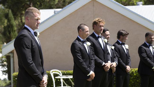 O'Brien waits for his fiancee to come down the aisle, with Jake Kelly and Ned McHenry among his groomsmen. Picture Brett Hartwig