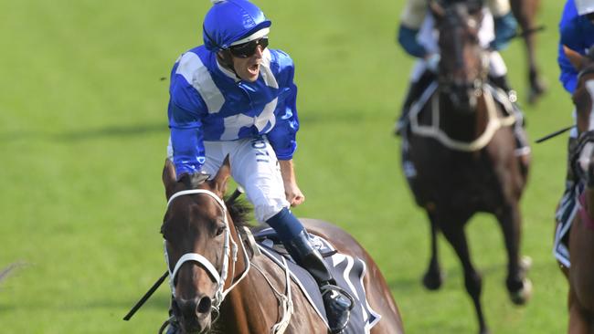 Hugh Bowman lets out a roar as Winx passes the finish line. Picture: AAP Image/Simon Bullard