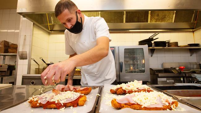 Executive Chef Christian Abbott prepares parmas at The Local pub in Port Melbourne. Picture: Mark Stewart