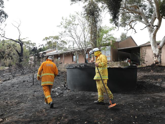 Ashbourne CFS captain Rob Crase and CFS volunteer Todd Fisher-Kappler check around the house for hot spots. Picture: Dean Martin