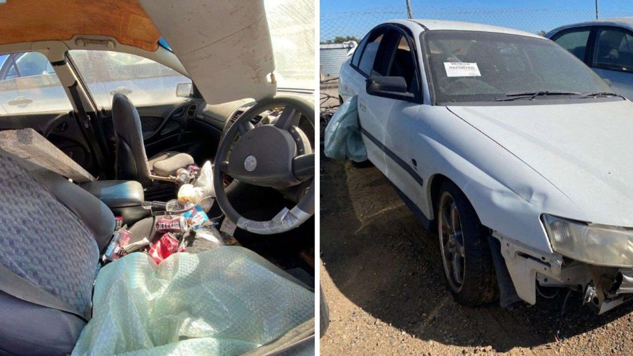 The 2002 Holden Commodore sedan, pictured with the front bumper missing and rubbish inside.