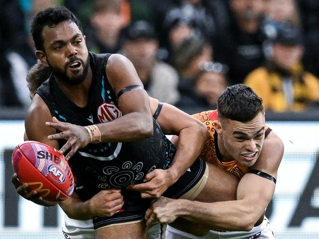 Willie Rioli is tackled by former Port Adelaide player Karl Amon. Picture: Mark Brake/Getty Images