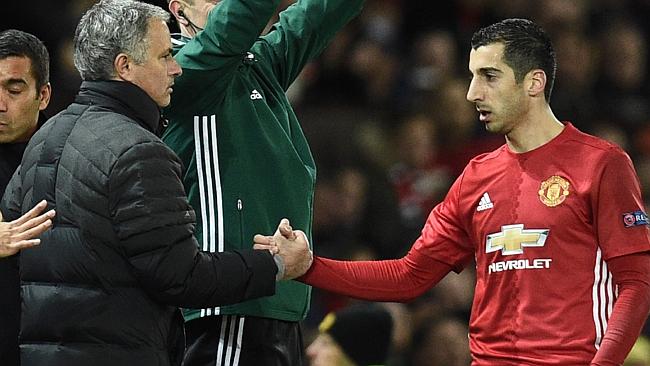 Manchester United's Armenian midfielder Henrikh Mkhitaryan (R) shakes hands with manager Jose Mourinho.