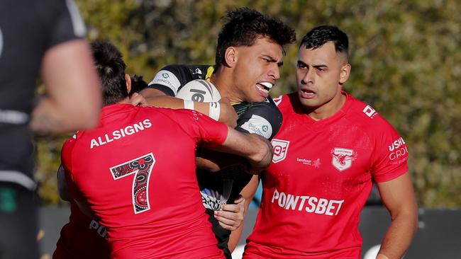 Michael Burgess of Currumbin Eagles tackles Campbell Pirihi of Helensvale Hornets. Photo: Regi Varghese