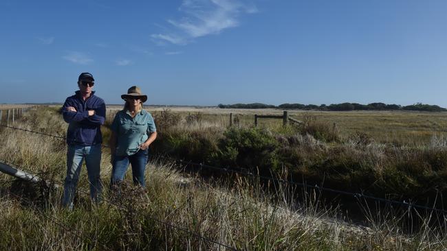 Joanne Feast and her son Morgan, beside the dried-up drain on their fifth-generation family farm near Mount Gambier. Picture: Jessica Dempster