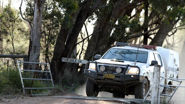 Police enter the property during the operation. Picture: Neil Keene