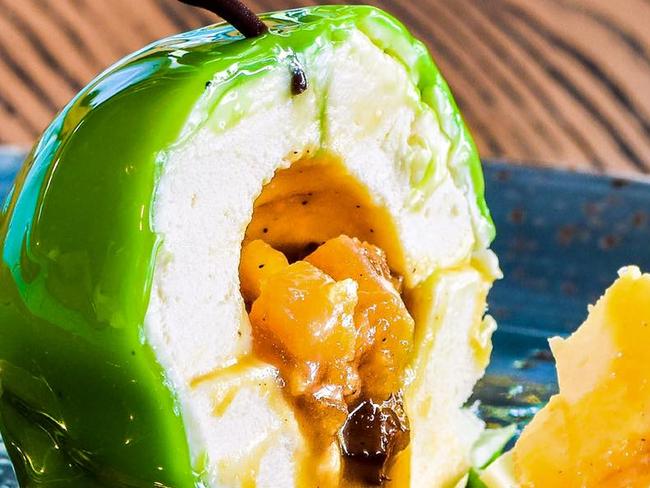 Patissez’s Apple Bombe — apple calvados mousse sphere filled with a salted caramelised apple crumble, dipped in white chocolate with a green glaze. Picture: Facebook Patissez