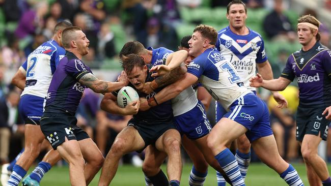 MELBOURNE, AUSTRALIA - APRIL 03: Alec MacDonald of the Storm is tackled during the round four NRL match between the Melbourne Storm and the Canterbury Bulldogs at AAMI Park on April 03, 2022, in Melbourne, Australia. (Photo by Graham Denholm/Getty Images)